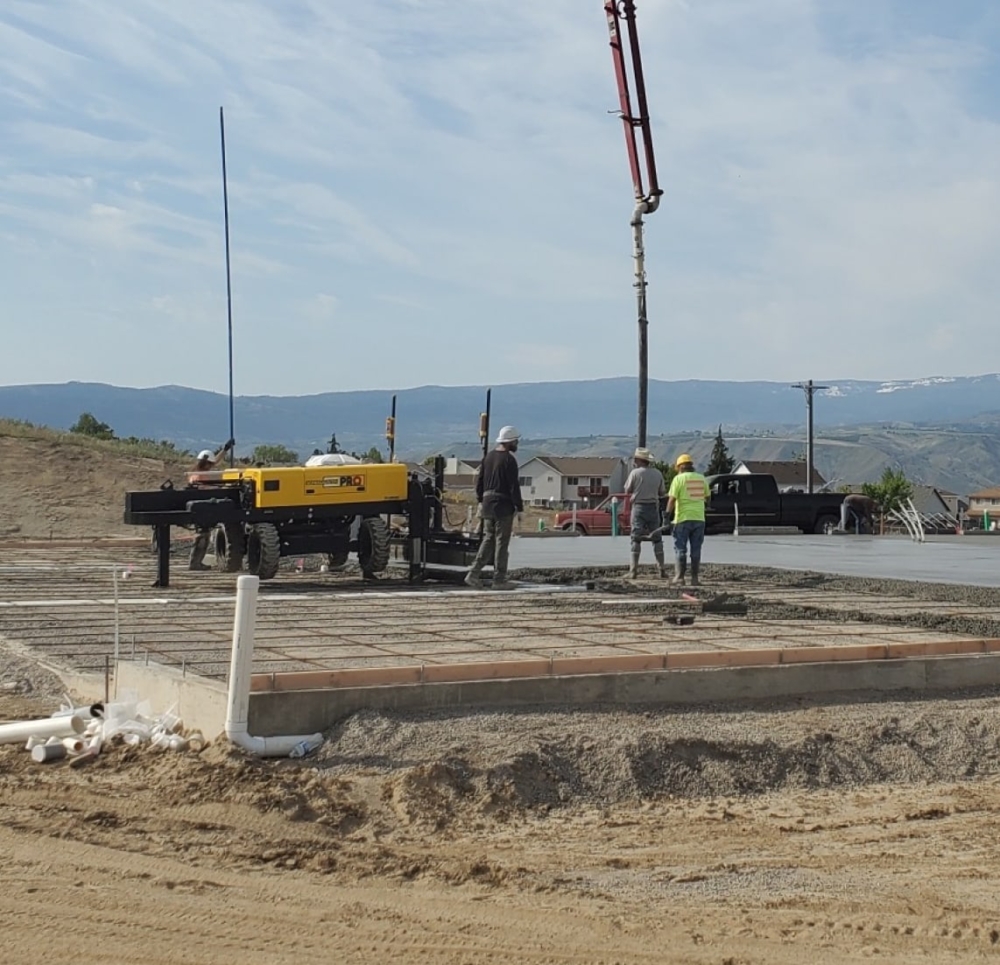 Concrete pump pouring slab foundation in central Washington