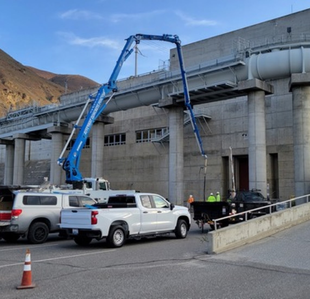 Concrete pump pouring concrete for industrial building in central Washington